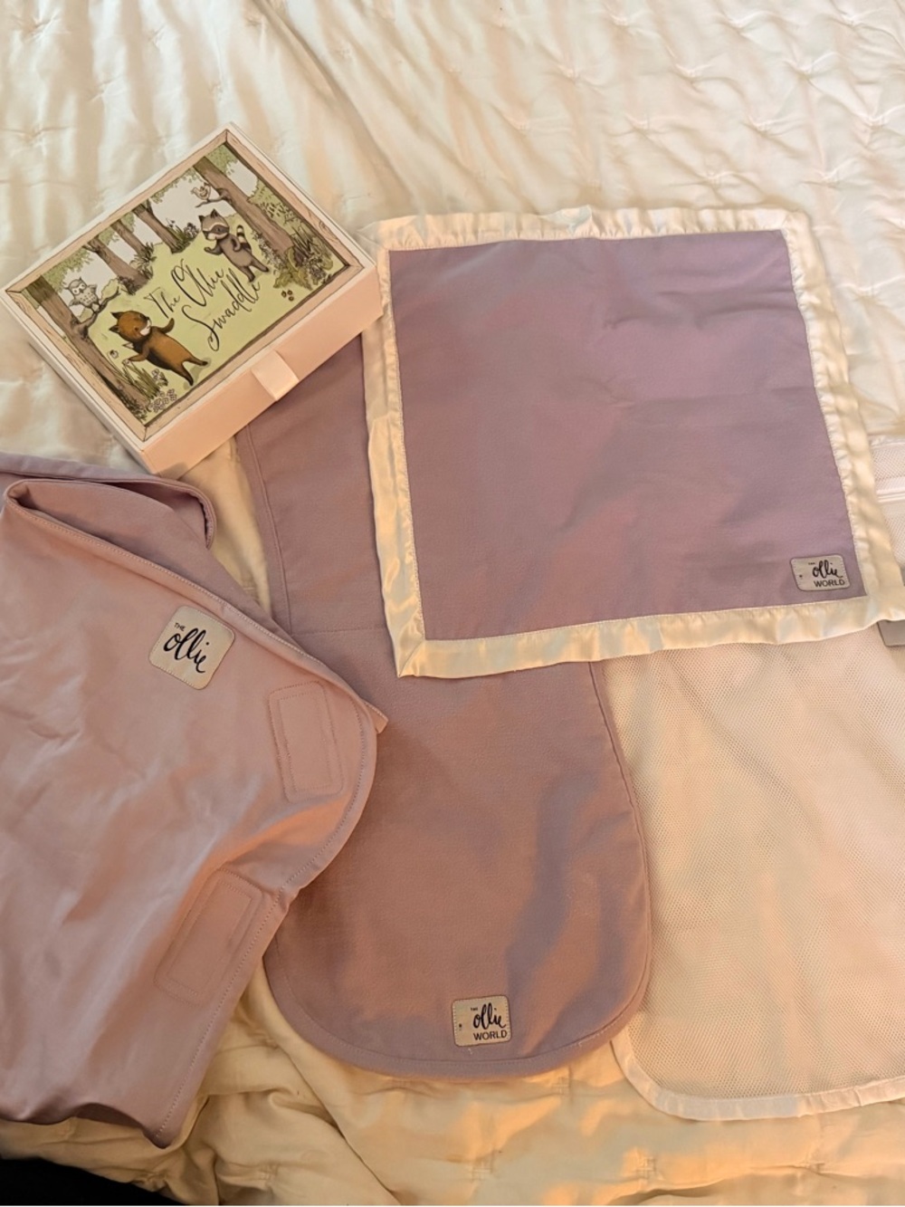 Olli Lavender Swaddle, burp cloth, laundry bag, and blanket.